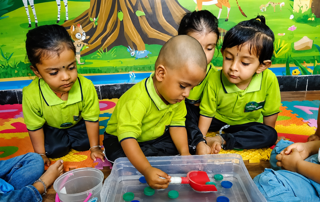Young children exploring a hands-on sensory learning activity at Hummingbird Preschool in Bangalore, building curiosity, confidence, and early developmental skills through experiential learning.